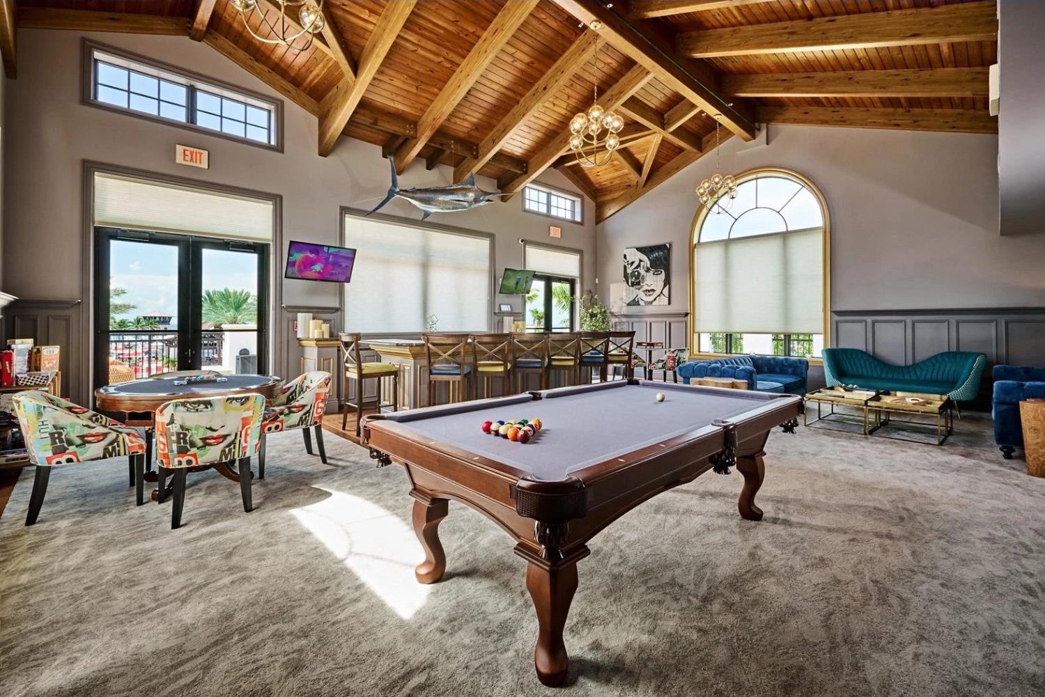 Club room with billiards under a vaulted wood ceiling