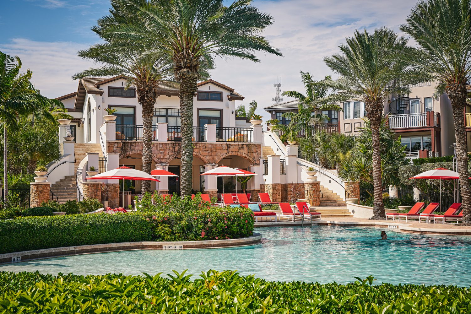 The resort's beach-entry lagoon pool framed by residences and palms